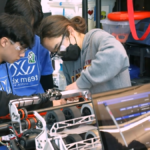 Xbot Robotics team works on robot at competition.
